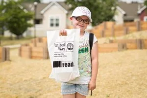 girl holding school supplies