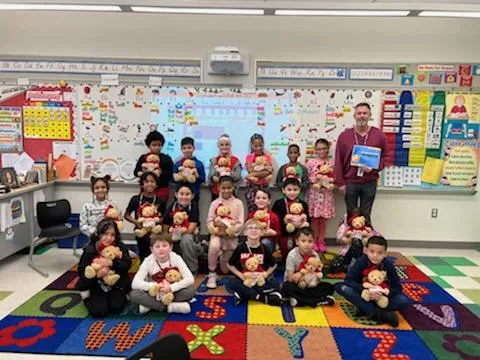 Children from Cheston Elementary School in Easton holding donated Godiva teddy bears