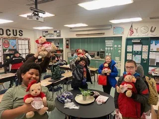 Donegan Elementary School class holding donated Godiva teddy bears