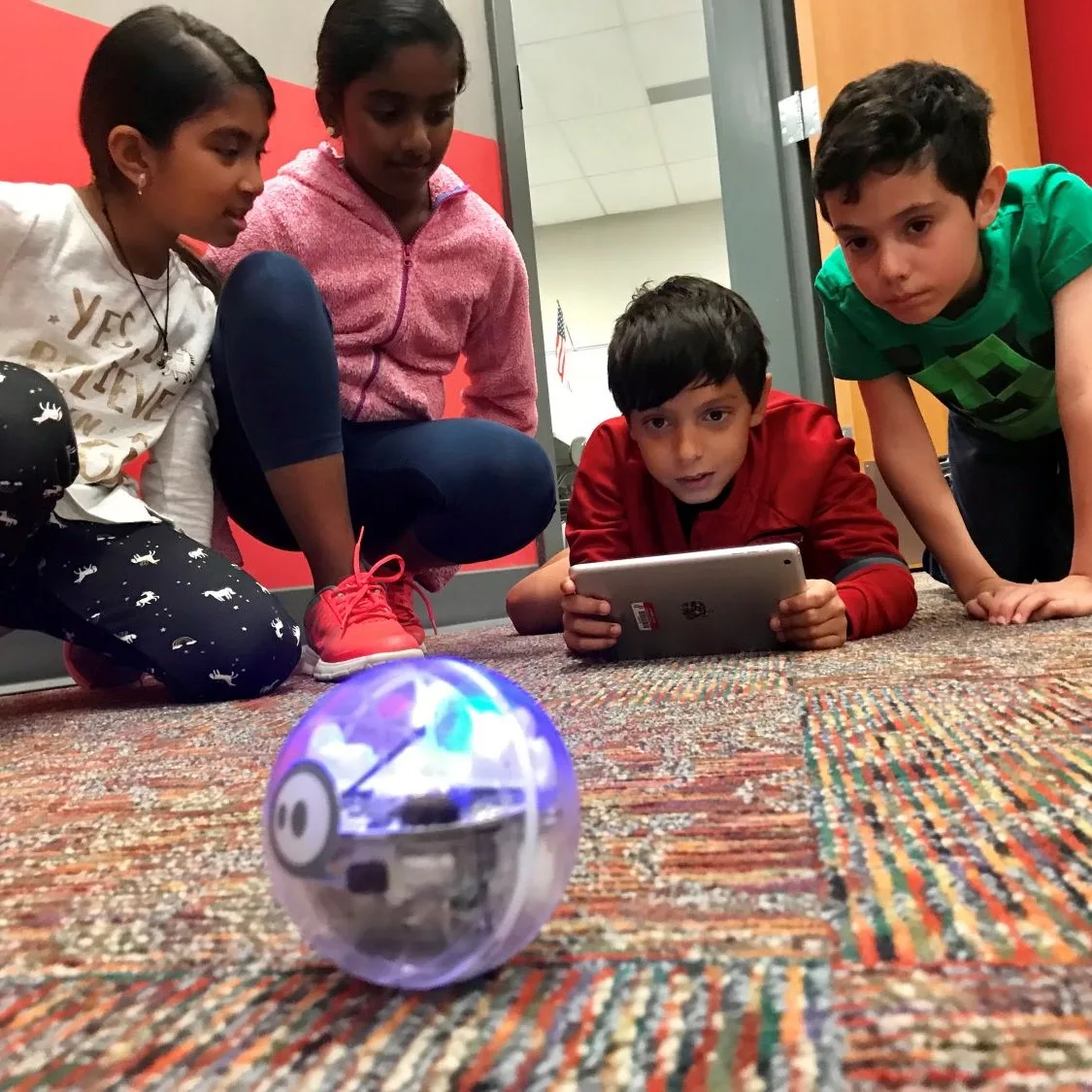 students using an ozobot in the Jaindl library makerspace to program and code