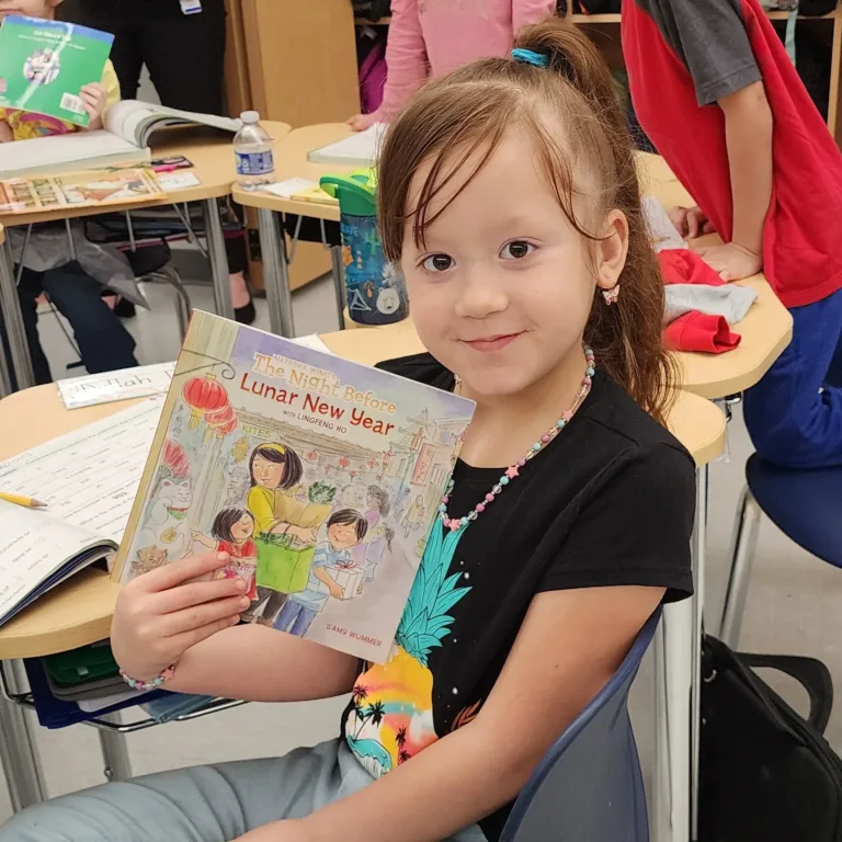 Child posing with book during Read Across America Day