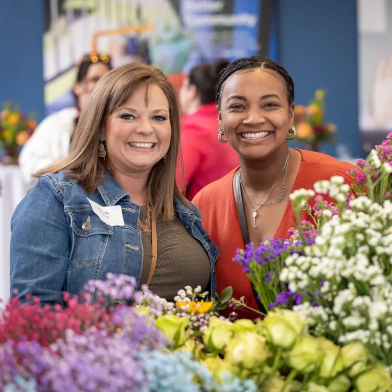 Women surrounded by flowers at the United Way Women United and Crayola Flowers event