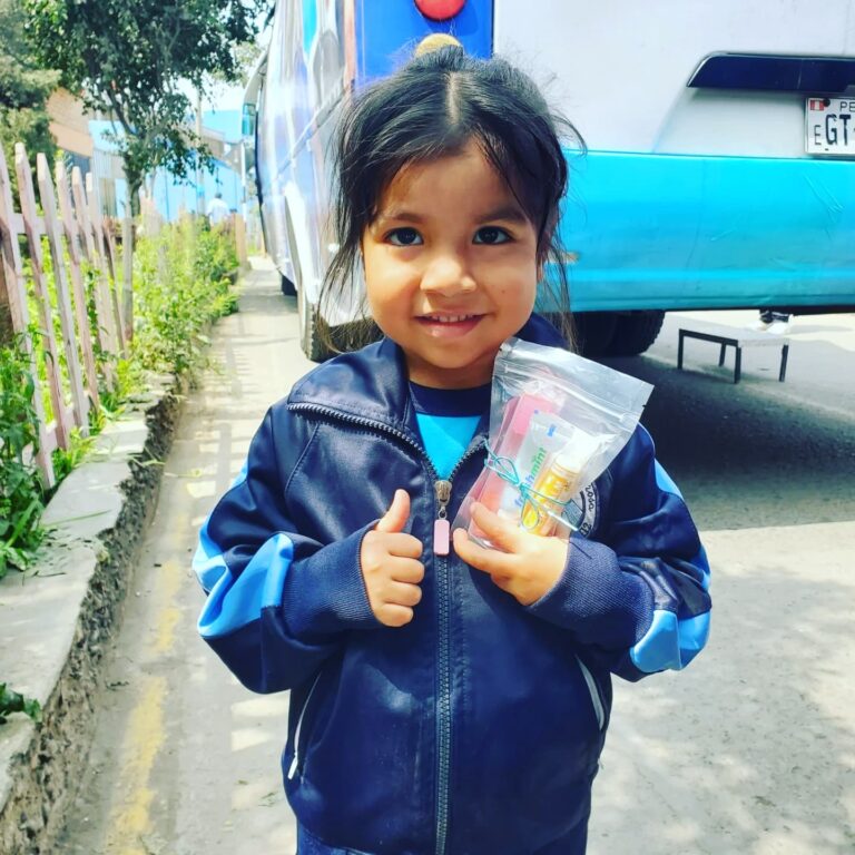smiling child holding a Joy Maker bag